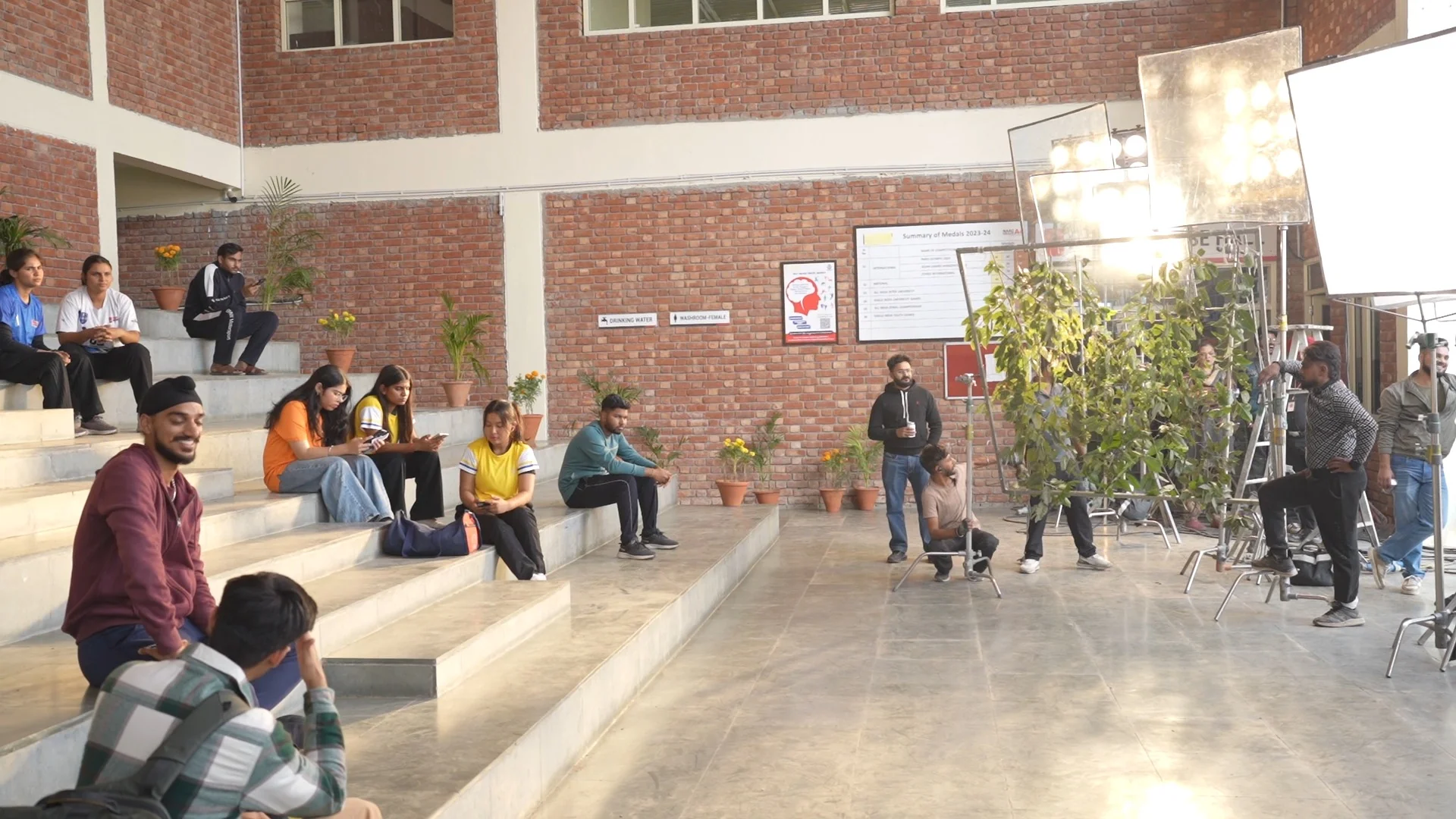 Indoor film set with lighting and production crew