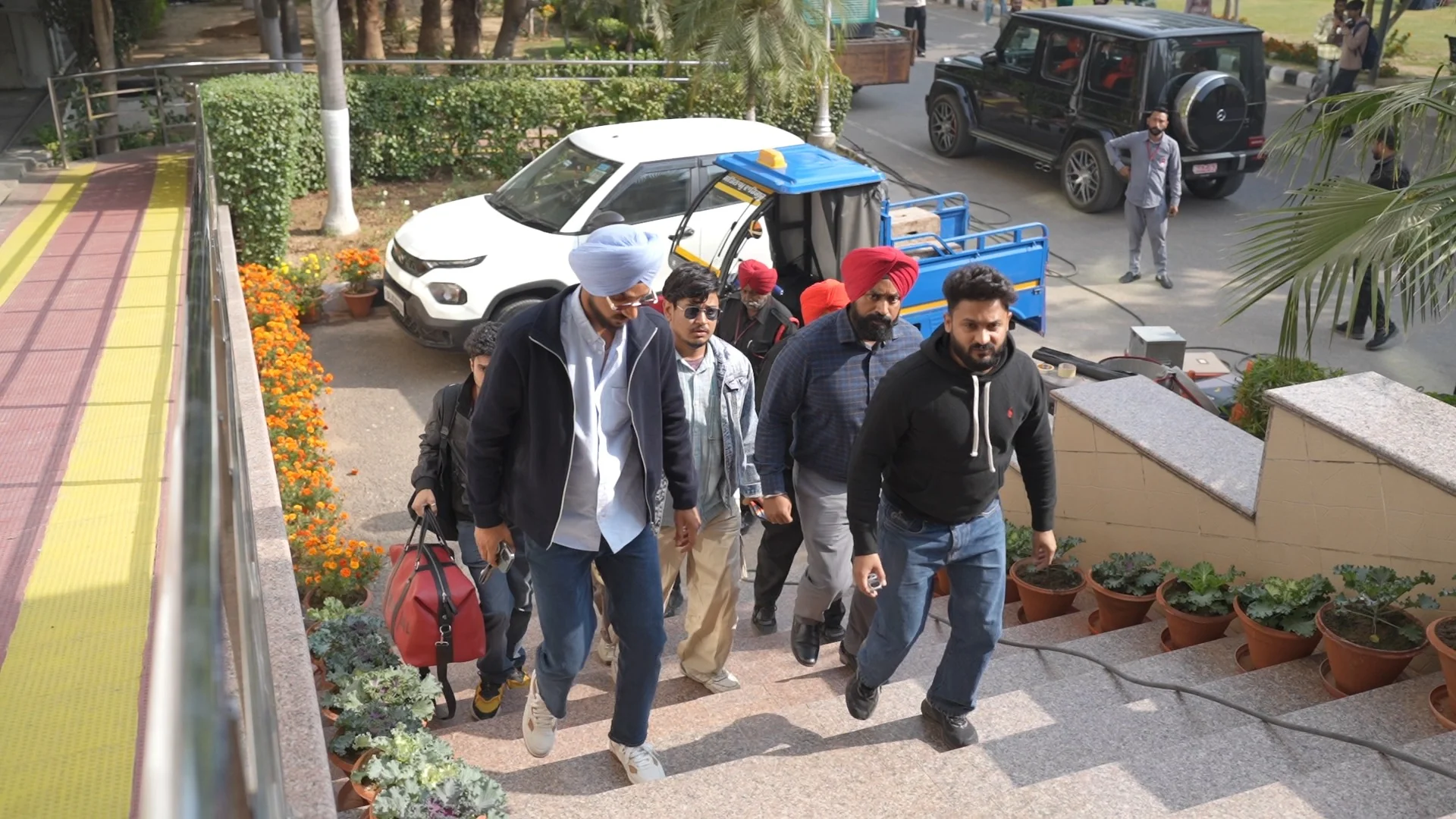 Cast and crew arriving at an outdoor location