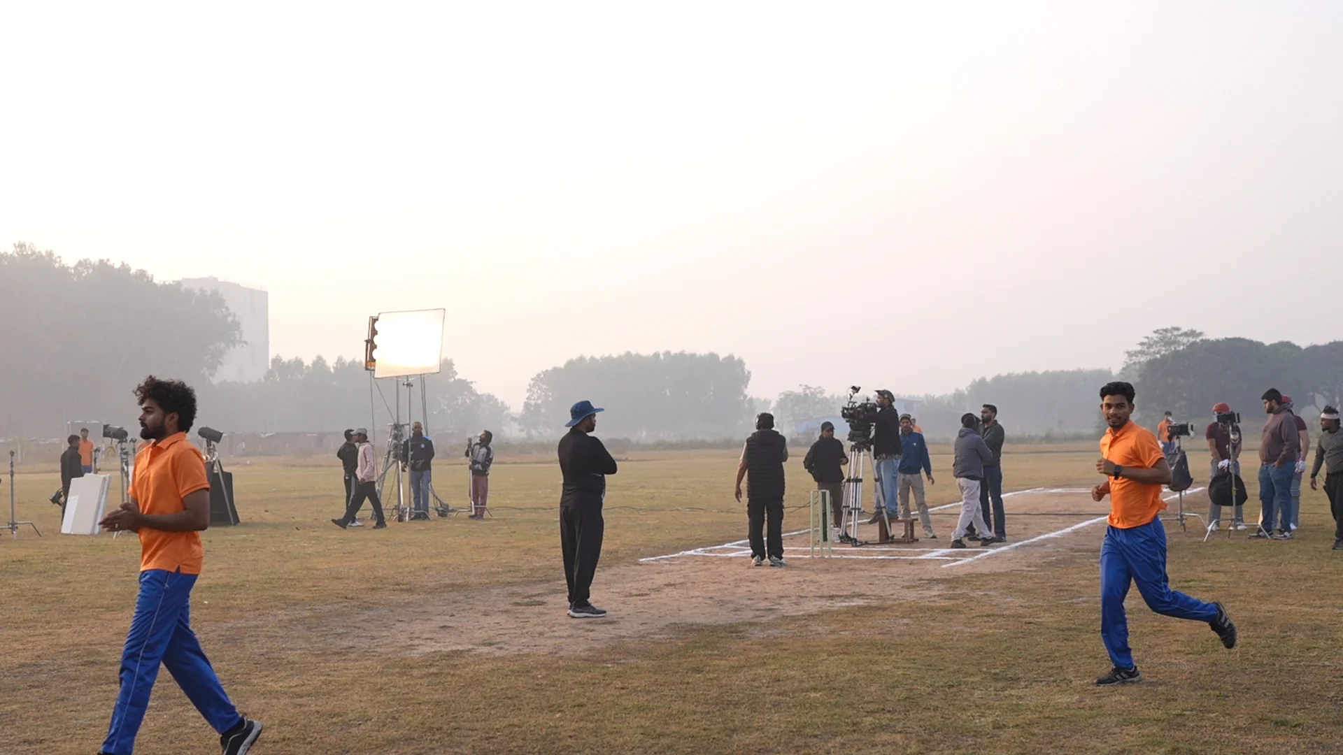 Crew preparing an outdoor sports field shoot