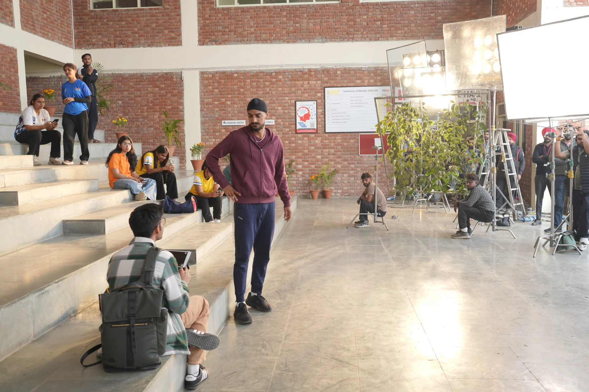 Actor and production crew on the indoor set