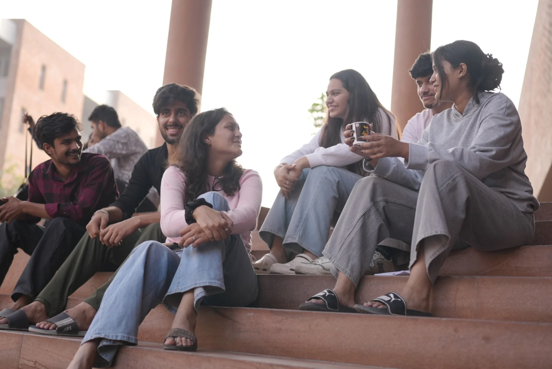 Cast seated together between takes
